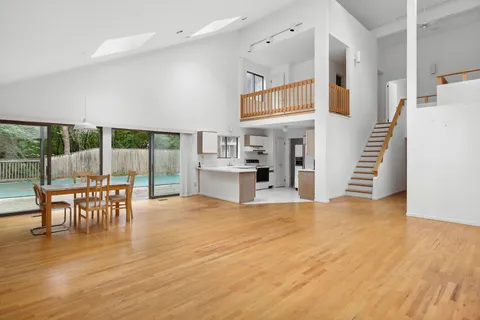 an empty room with wooden floor and furniture