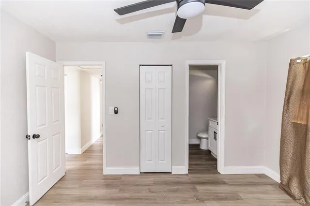 a view of a livingroom with wooden floor and staircase