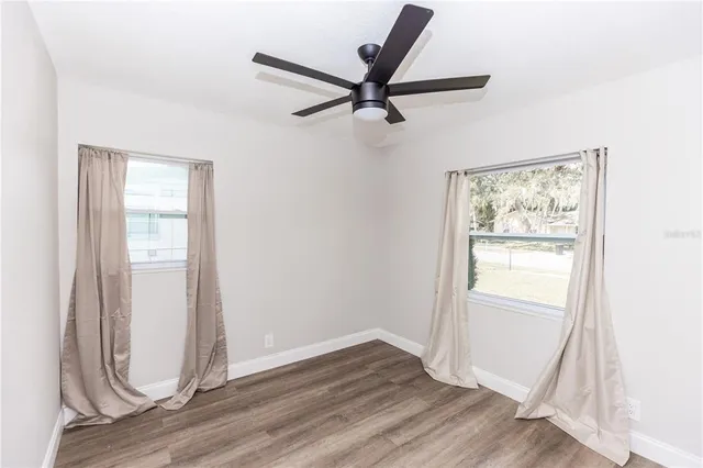 a view of a livingroom with wooden floor and a window