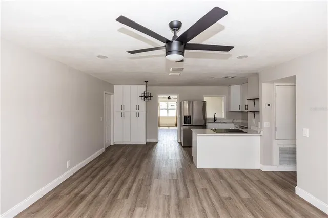 a view of a kitchen with a sink and wooden floor