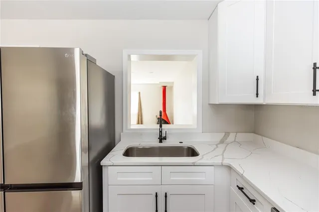 a kitchen with a sink and a refrigerator