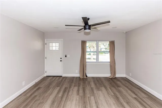 wooden floor in an empty room with a window