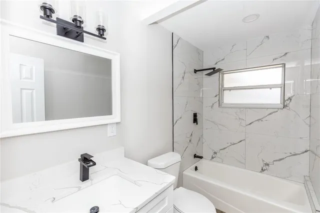 a bathroom with a sink a toilet and a bathtub