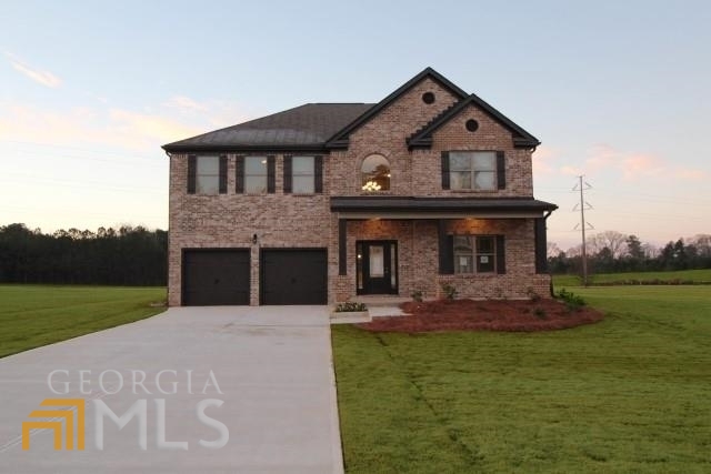 937 Eldridge Road, Unit 84 Hampton, GA 30228 - Photo 1 of 1 a front view of a house with a yard