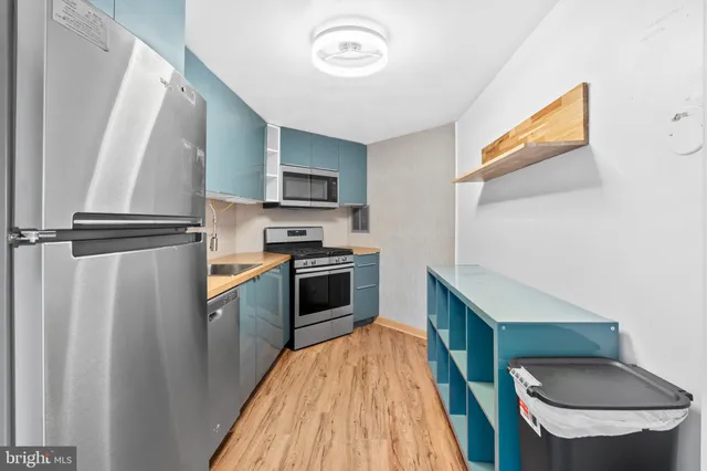 a kitchen with stainless steel appliances a stove microwave and a refrigerator