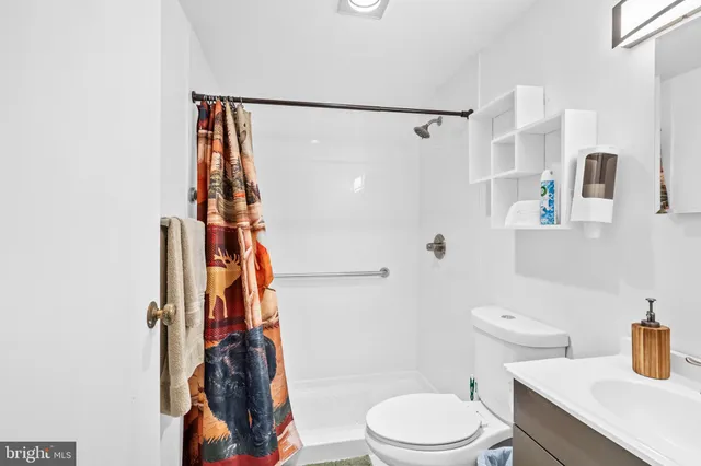 a white toilet sitting next to a bathroom sink