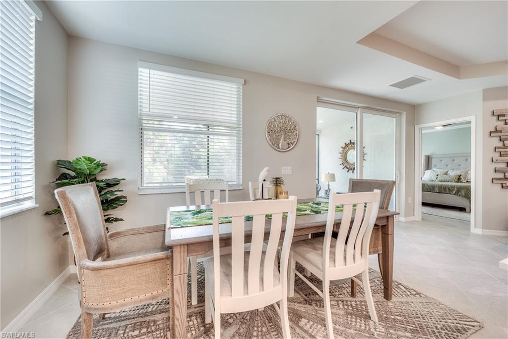 3790 Pebblebrook Ridge Court, Unit 101 Fort Myers, FL 33905 - Photo 18 of 38 a view of a dining room with furniture and window
