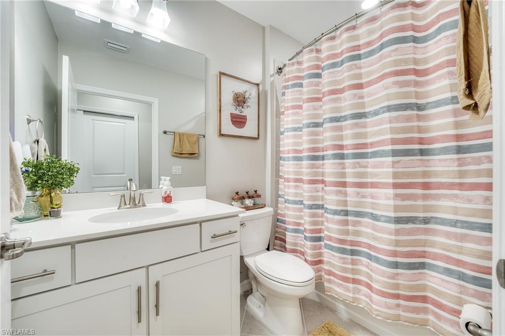 3790 Pebblebrook Ridge Court, Unit 101 Fort Myers, FL 33905 - Photo 25 of 38 a bathroom with a sink a toilet and mirror