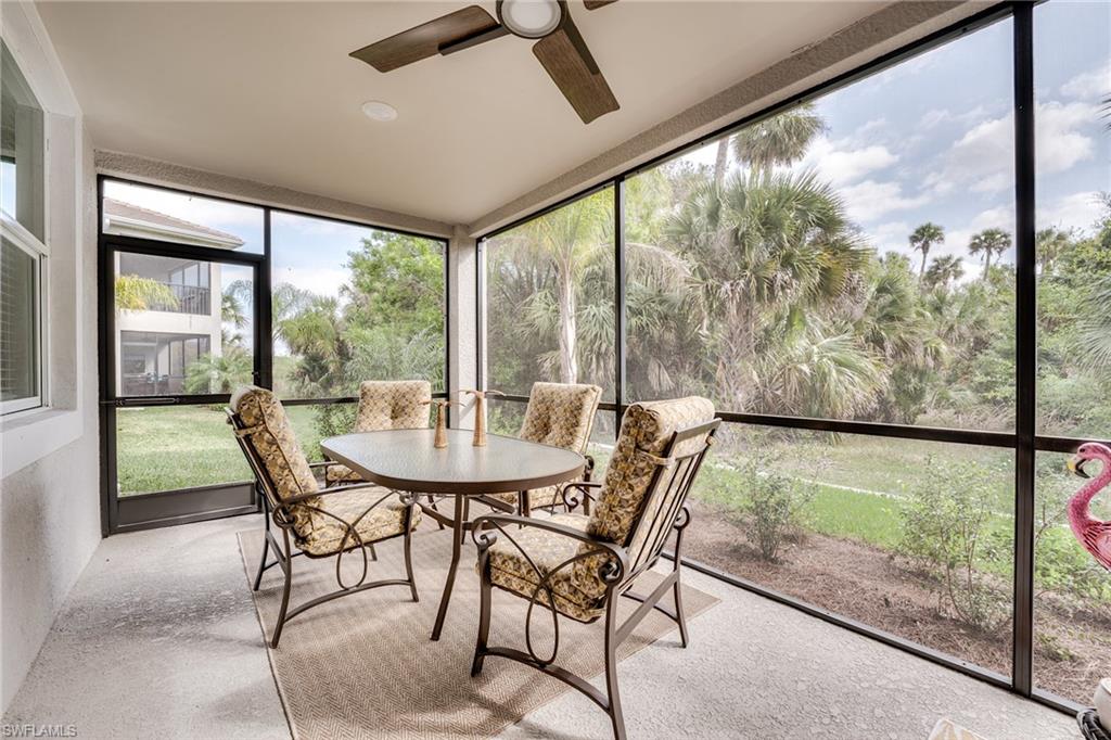 3790 Pebblebrook Ridge Court, Unit 101 Fort Myers, FL 33905 - Photo 36 of 38 a view of a city from a dining room with large windows and wooden floor