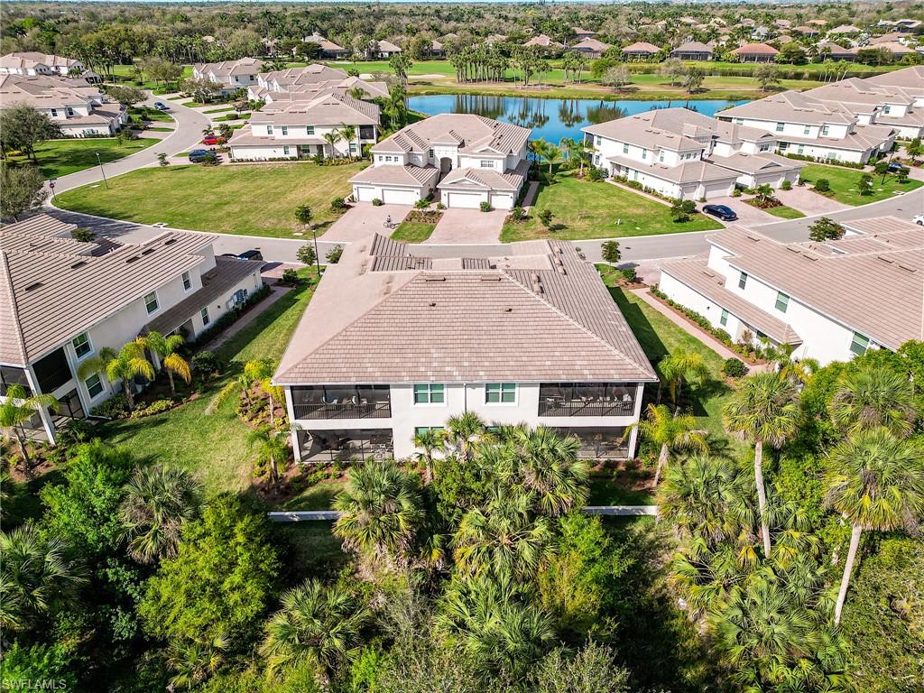 3790 Pebblebrook Ridge Court, Unit 101 Fort Myers, FL 33905 - Photo 6 of 38 an aerial view of a house with a yard and lake view