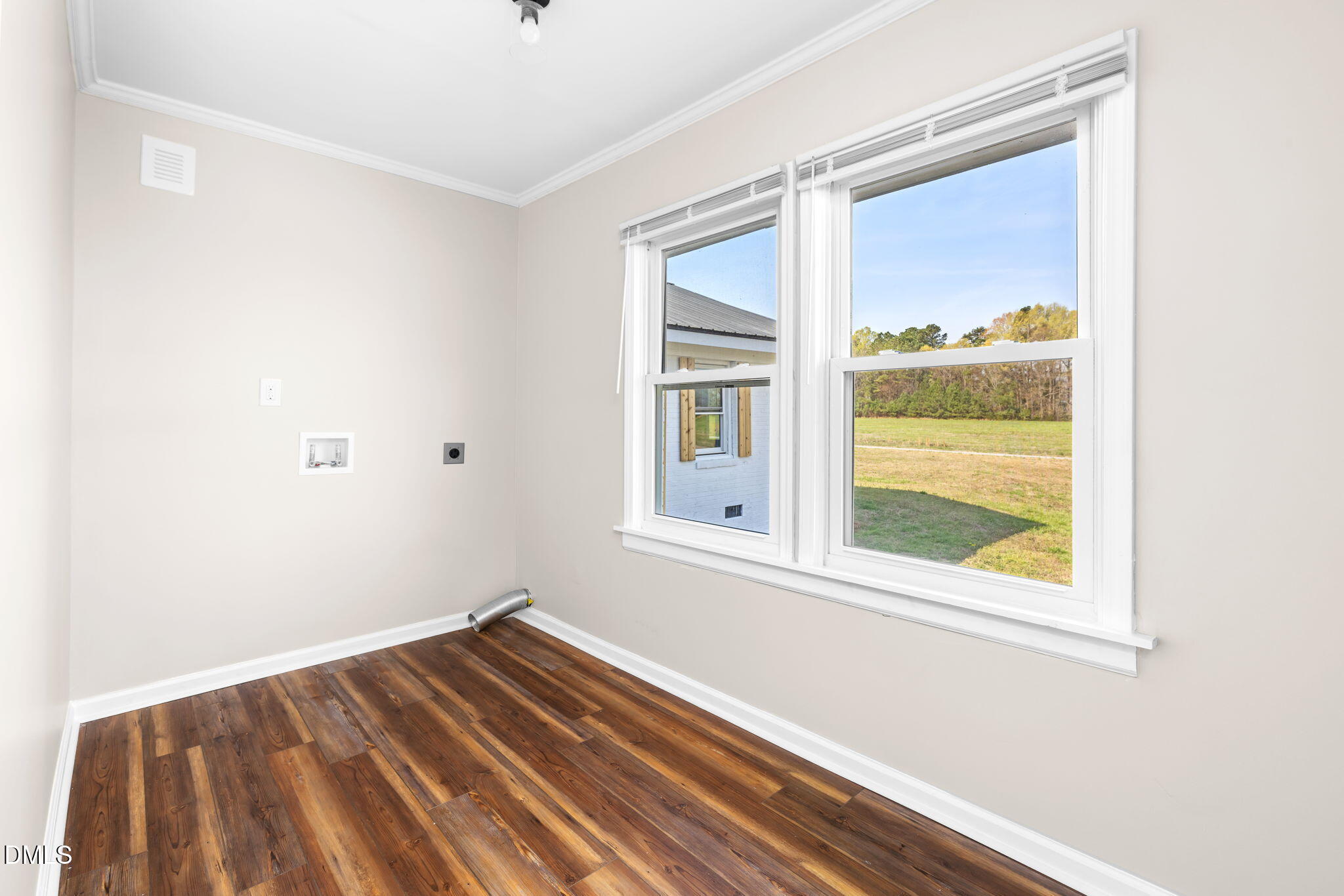 426 Rooker Dairy Road Norlina, NC 27563 - Photo 20 of 33 a view of an empty room with wooden floor and a window