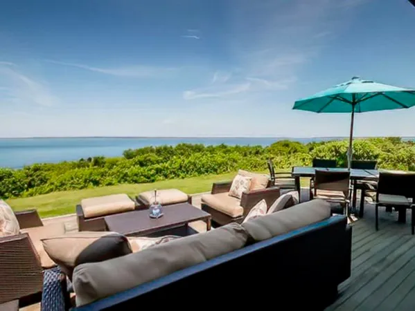 a outdoor living room with furniture and a garden