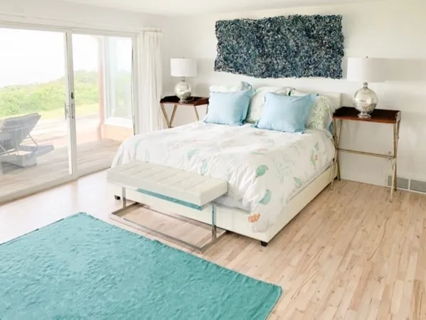 a bed sitting in a bedroom next to a large window
