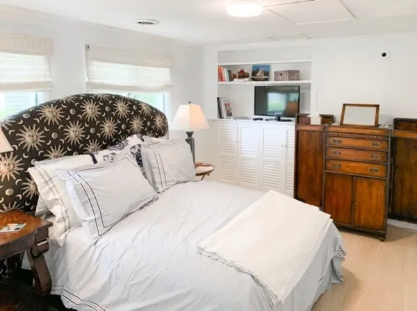 a bedroom with a bed and dresser
