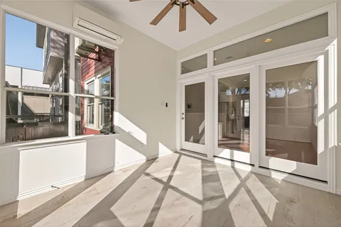 a bedroom with a bed and a large window