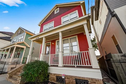 a view of an empty room with wooden floor a ceiling fan and windows