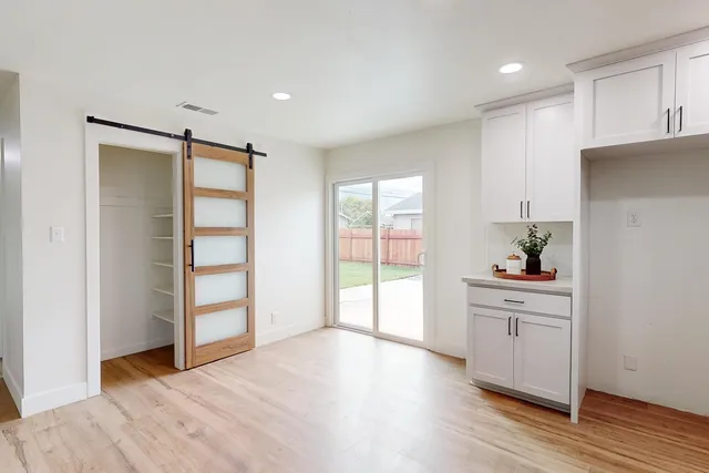 a view of a kitchen with wooden floor and a sink
