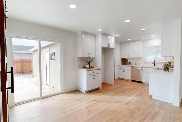 a kitchen with white cabinets and white appliances
