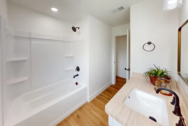 a bathroom with a tub and sink