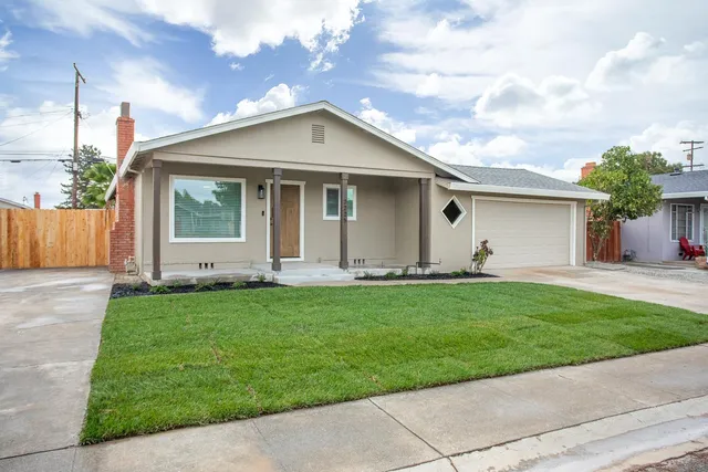 a front view of house with yard and green space