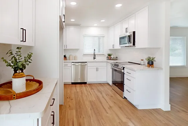 a kitchen with a sink appliances and cabinets