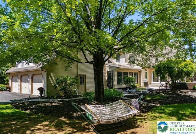 a kitchen with granite countertop a stove a sink and white cabinets with wooden floor