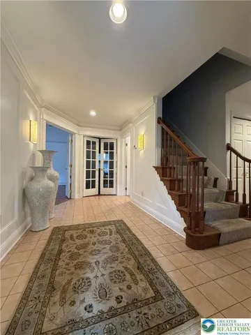 a living room with furniture a table and a large window