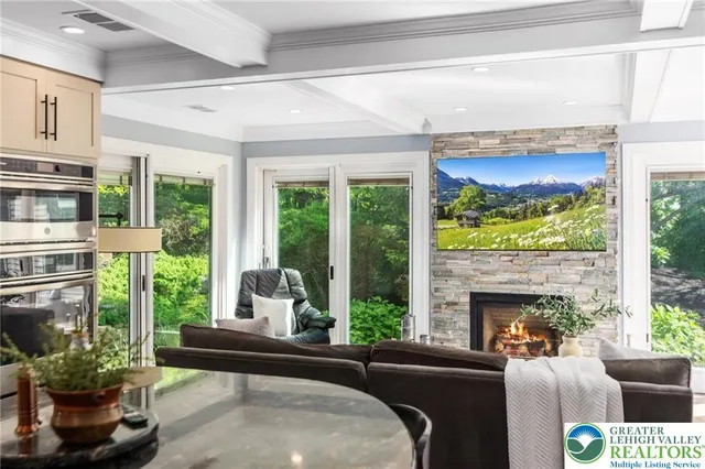 a living room with furniture a window and a clock