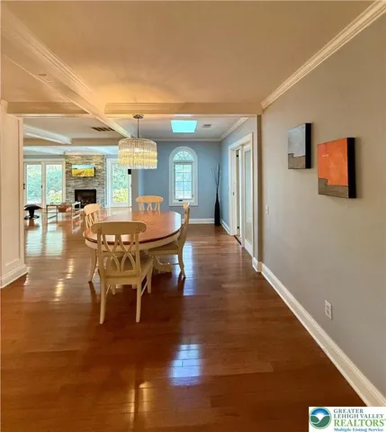 a view of an empty room with a windows and fireplace