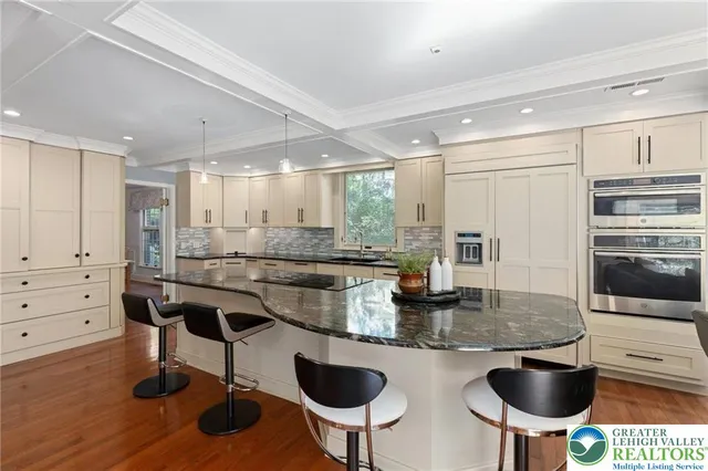 a bathroom with a granite countertop sink mirror vanity and toilet