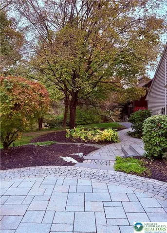a view of house with backyard tub and outdoor seating