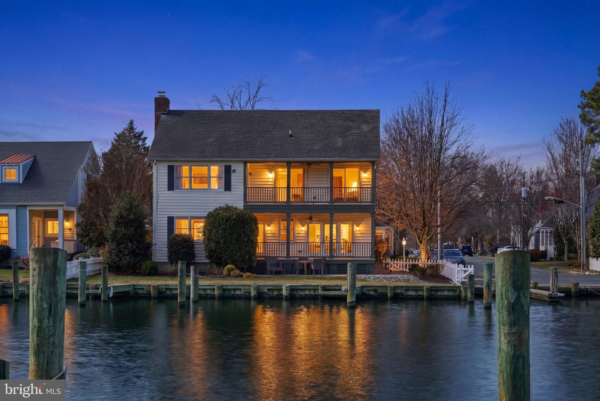 a view of a house with lake view and a yard