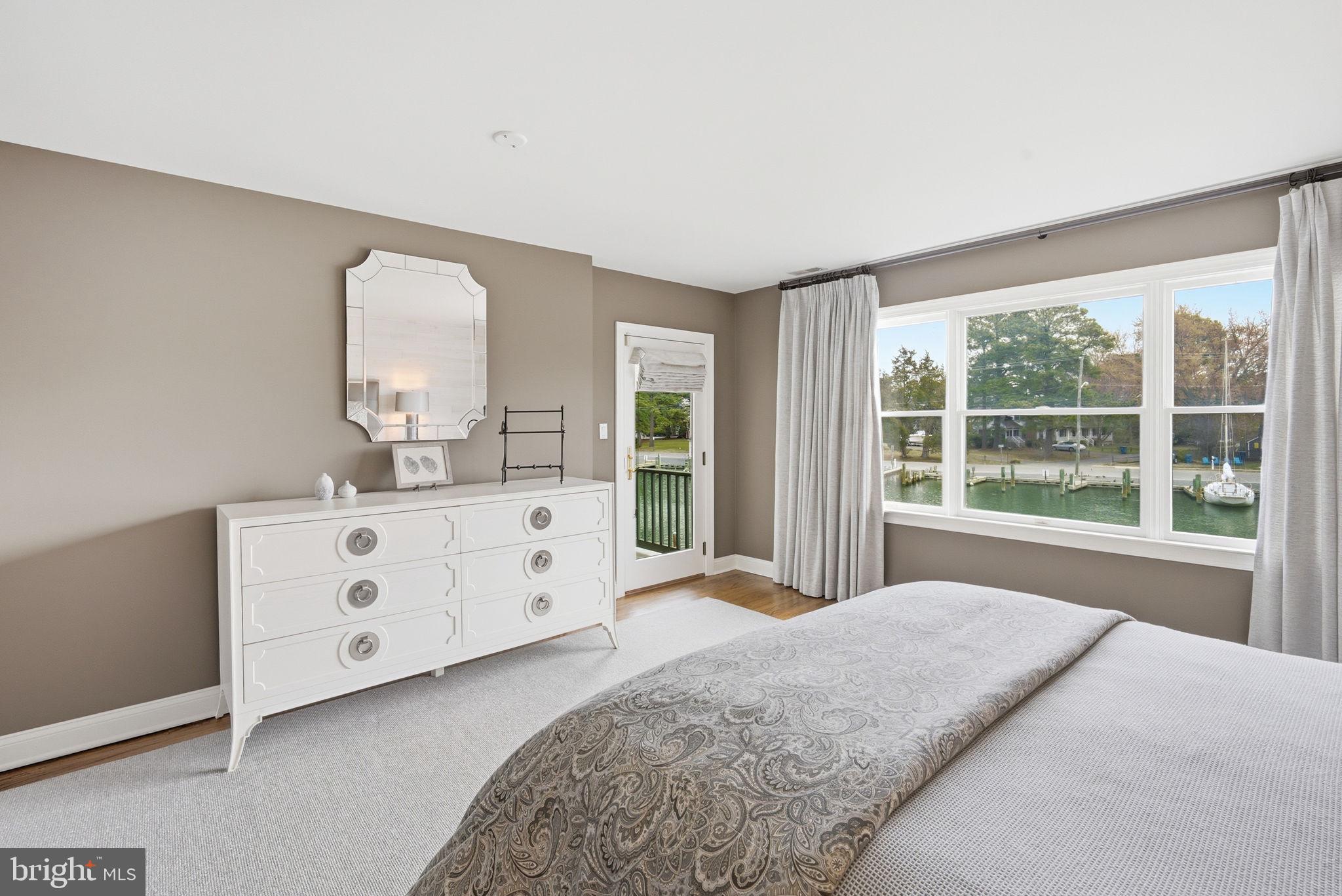 222 East Chestnut Street St. Michaels, MD 21663 - Photo 27 of 58 a spacious bedroom with a large bed and a window