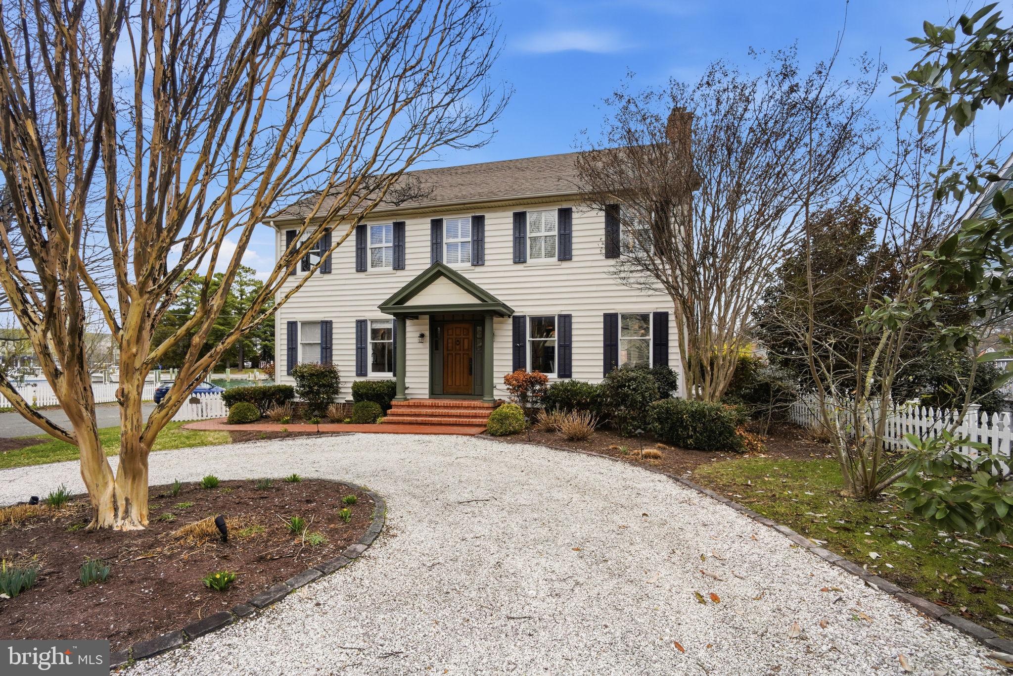 222 East Chestnut Street St. Michaels, MD 21663 - Photo 53 of 58 a front view of a house with garden and trees