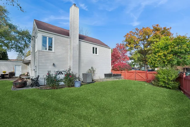 a front view of house with yard and outdoor seating