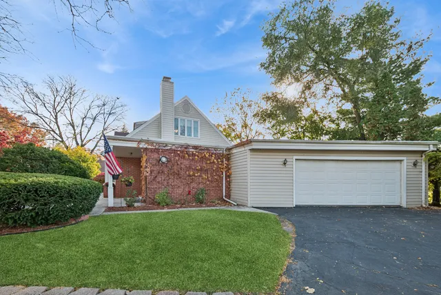 a front view of a house with a garden and yard