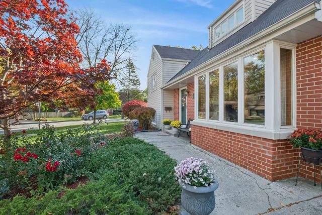 a view of a house with backyard sitting area and garden