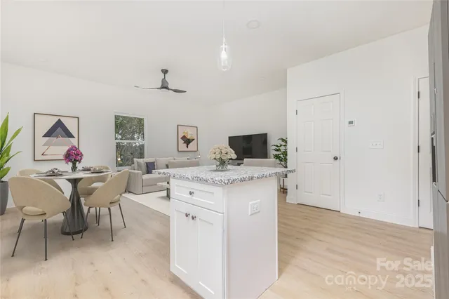 a living room with furniture a rug and white walls