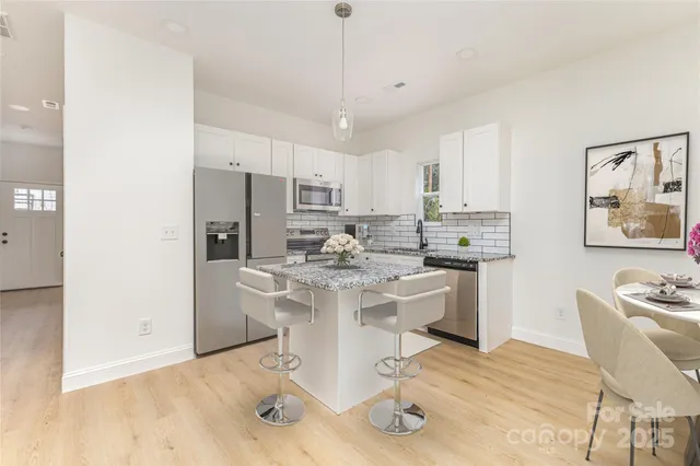 a kitchen with a sink appliances and cabinets