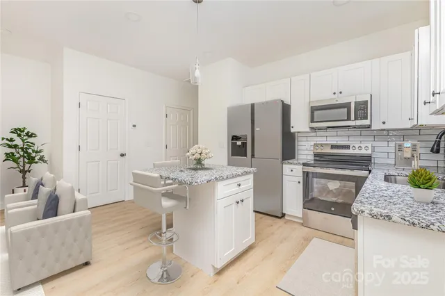 a kitchen with a refrigerator and a sink