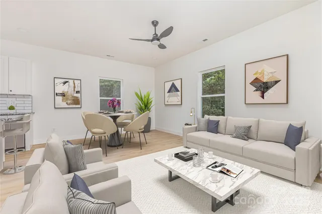 a living room with furniture a rug and a window