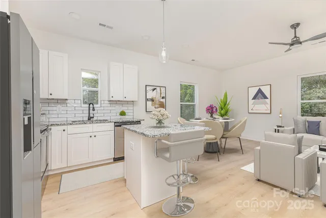 a kitchen with a sink stove and view living room