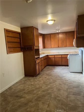 a kitchen with stainless steel appliances a refrigerator and wooden cabinets