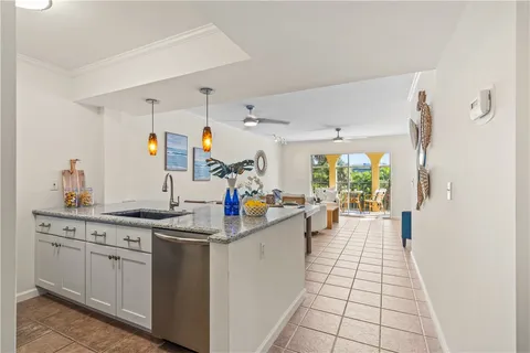 a kitchen with a sink and white cabinets