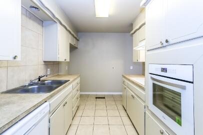 5408 31st Street Lubbock, TX 79407 - Photo 15 of 33 a kitchen that has a sink and a stove in it