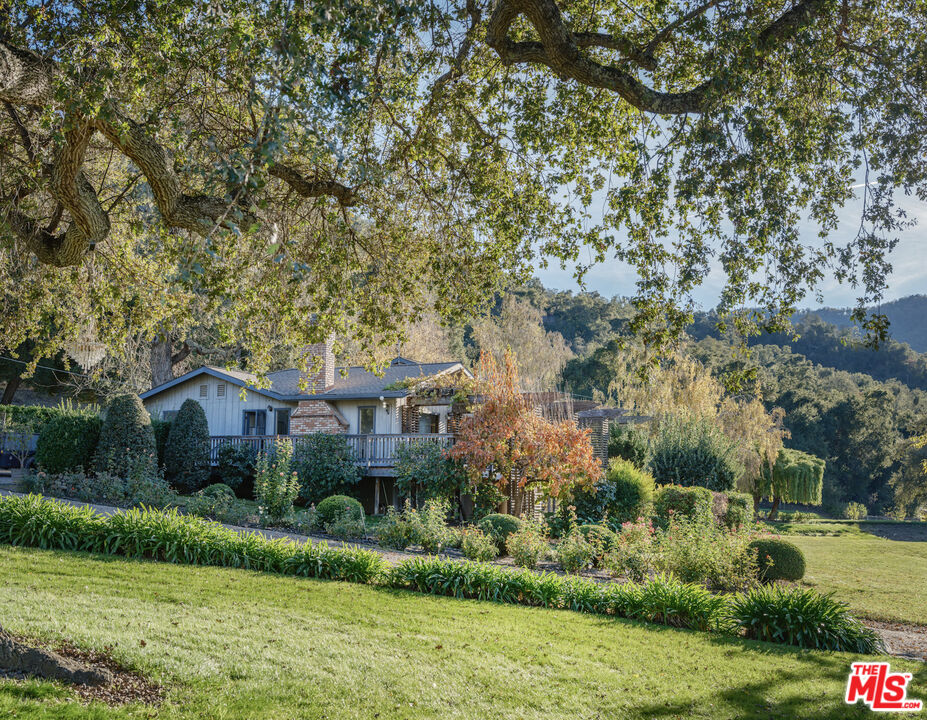 20300 Cachagua Road Carmel Valley, CA 93924 - Photo 10 of 37 a front view of a house with a garden