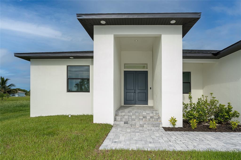 191 Tournament Road Rotonda West, FL 33947 - Photo 13 of 41 a front view of a house with garden