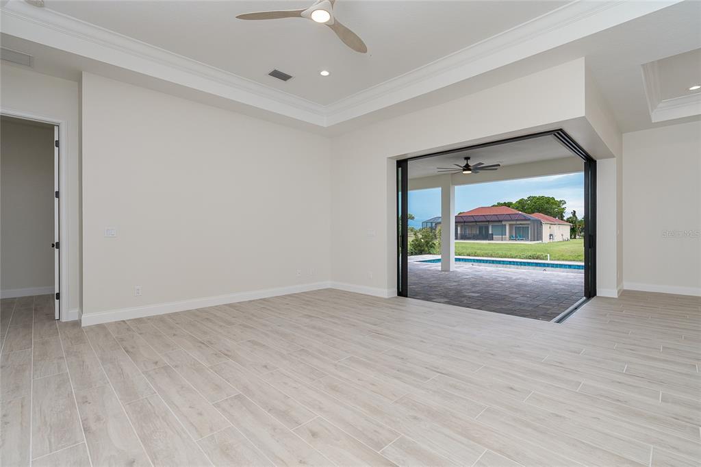 191 Tournament Road Rotonda West, FL 33947 - Photo 16 of 41 wooden floor in an empty room with window