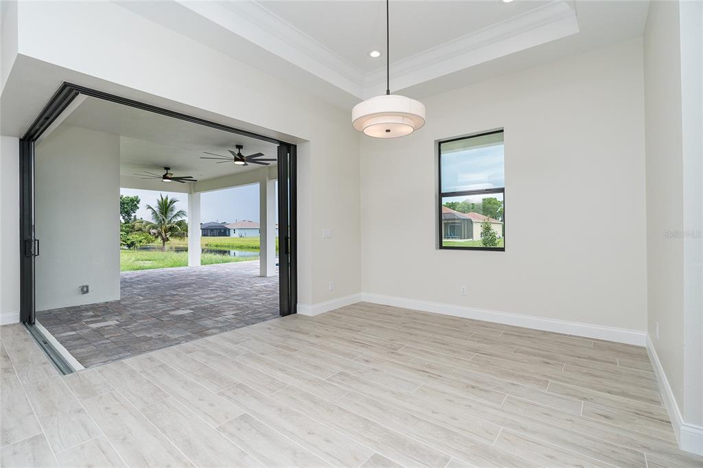 191 Tournament Road Rotonda West, FL 33947 - Photo 20 of 41 a view of an empty room with a window and wooden floor