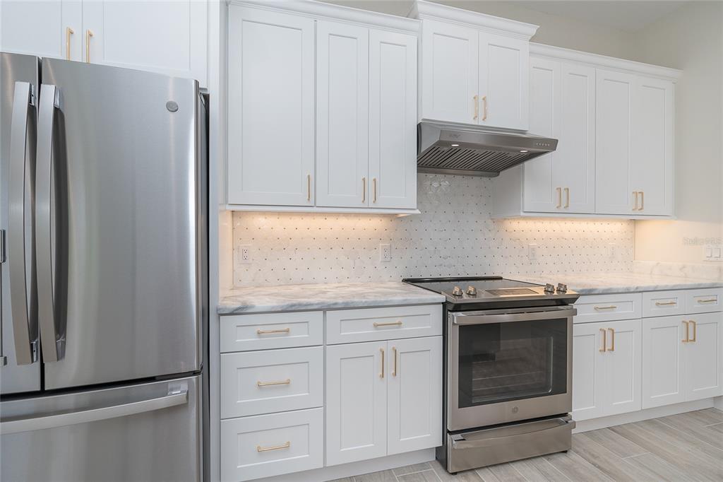 191 Tournament Road Rotonda West, FL 33947 - Photo 23 of 41 a kitchen with stainless steel appliances granite countertop white cabinets and a refrigerator